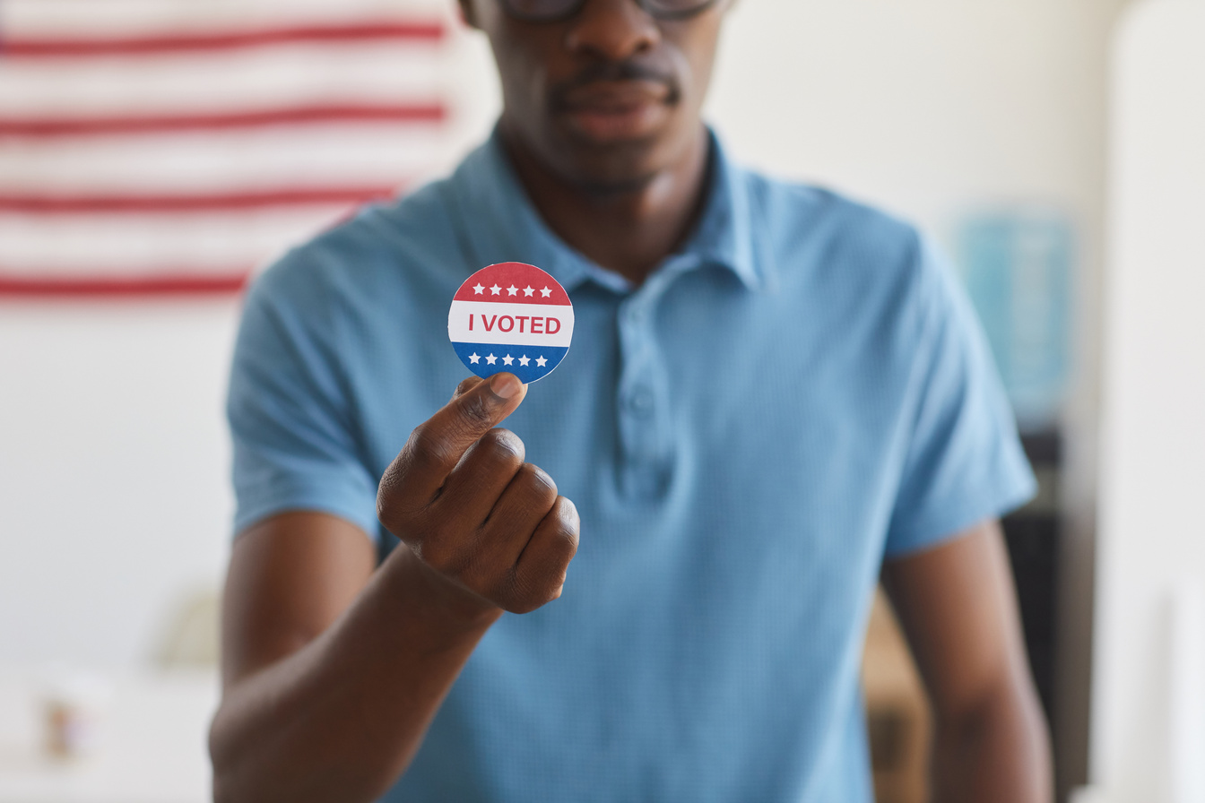 African-American Man Holding I VOTED Sticker