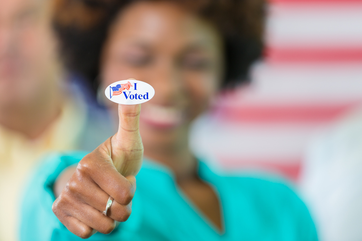 Happy African American woman with an I Voted sticker